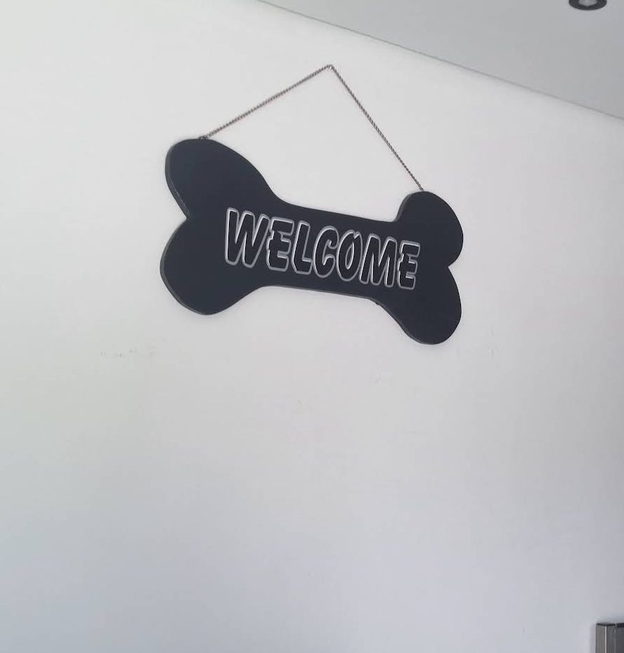 A bone-shaped Welcome sign inside the salon